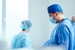 © Iryna - Surgeons in sterile uniforms preparing for operation in hospital operating room