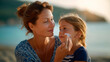 © Kateryna - Faceless mother applying suntan lotion on daughter face family sun protection stock photo child skincare SPF application parental care beach safety defocused background with