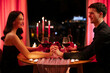 © Home-stock - Couple in love holding hands, having romantic dinner in restaurant and celebrating Valentine's day, side view