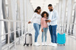 © Prostock-studio - Happy African American Family Of Three People Of Color Checking Info Of Their Flight In Airport. Smiling Black Dad, Mum And Daughter Looking At Tickets, Waiting For Departure, Free Copy Space