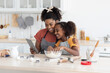 © Prostock-studio - African american mother and daughter baking together at home, watching online culinary blog, using digital tablet, happy black mom and teen kid making dough for pastry, taking selfie on pad
