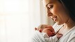 © kodidesign - Young mother holding her sleeping newborn baby. A tender moment of maternal love and family bonding with copy space
