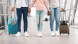 © Prostock-studio - Family Travel Concept. Low section cropped closeup view of black dad, mum and girl standing at departure lounge with suitcases waiting for the aircraft arrival, three people holding hands, banner