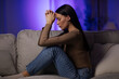 © Home-stock - Upset woman sitting on sofa with her head down, deep in thought and feeling sadness from problems or divorce, side view