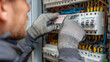 © Impete - Electrician inspecting an open electrical distribution box
