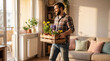 © Eduardo Accorinti - Man carrying daffodils, hyacinths and pansies in a wooden box, decorating apartment for spring season