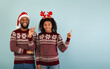 © Prostock-studio - Seasonal sales. Joyful african american couple pointing aside at empty space for your advertisement over blue background, panorama with free space. Holiday promo and offer
