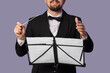 © Pixel-Shot - Male conductor with note sheets on grey background