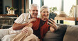 © peopleimages.com - Video call, smile or old couple in house with phone, connection or online conversation in living room. Happy, senior man or woman with tech, digital communication or bonding together on virtual app.