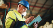 © peopleimages.com - Tablet, ecommerce and mature man in warehouse with email for cargo information with supply chain. Technology, industry and male logistics manager with online inventory for stock delivery from below.