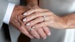 © Katsiaryna - Closeup of elderly hands celebrating lifelong partnership with tender touch and golden bands