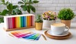 © vectorizer88 - Bright and Colorful Workspace with Coffee, Plants, and Color Swatches for Inspiration
