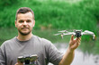 © AlexGo - Drone pilot teacher holding UAV looking into camera