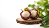Mangosteen sliced in half showing interior details on wooden surface, highlighting fruit freshness