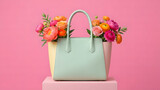 Elegant Pastel Handbag with Vibrant Spring Flowers on Pink Background.