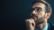 © Nany - A man in a suit looking thoughtful against a dark background.