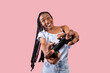 © Prostock-studio - Modern entertainments concept. Excited young black lady with joystick playing video game on pink studio background. Overjoyed Afro woman holding controller, enjoying online gaming
