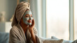 © Vasyl - Woman enjoying a spa day with a facial mask and a towel on her head. A woman relaxes at home with a face mask, promoting self-care and wellness