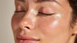 © Newleks - Woman's face showing close up of healthy, hydrated, and glowing skin with a dewy finish, emphasizing natural beauty, skincare, and freshness under soft light
