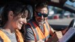 © Justlight - Focused instructor reviewing evaluation sheet in car observing candidate navigating mixed roads under bright daylight conditions.