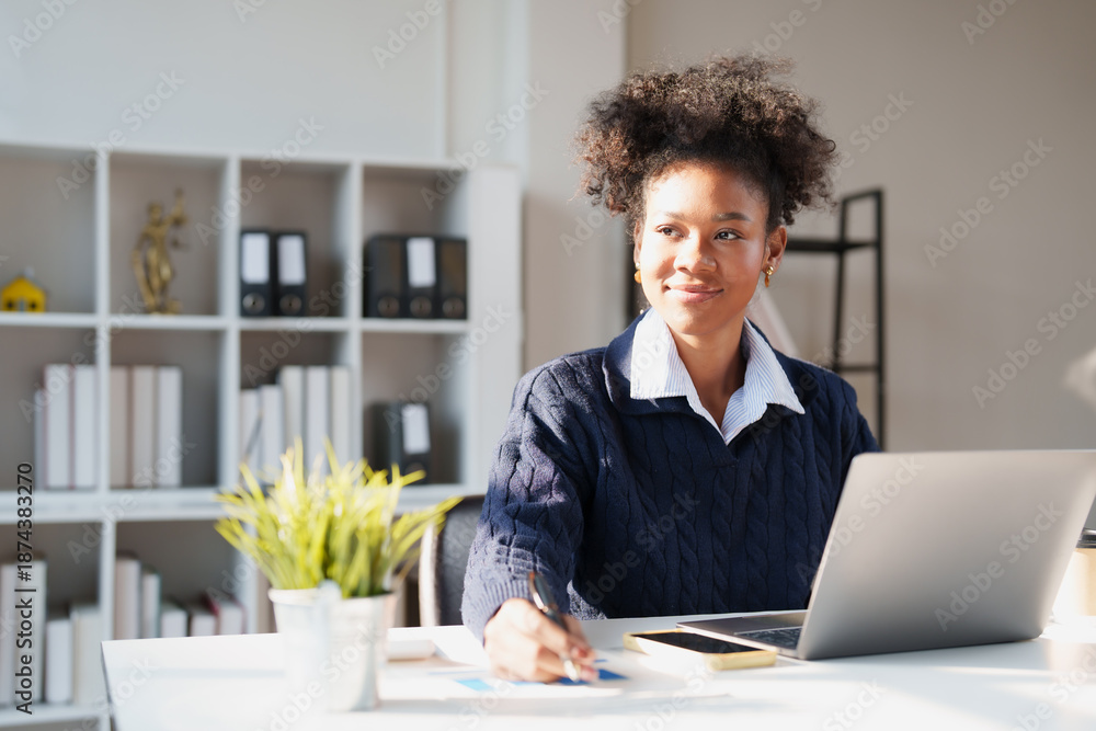 African American woman working diligently at a modern office desk ...
