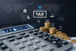 © cherdchai - Tax preparation workspace with calculator and gold coins for the year 2026, Tax planning and financial preparation for 2026 with calculator, income tax form, coins
