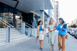 © Zoran Zeremski - Smiling businesswomen walking together outside modern office.