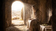 © PhotoGranary - Risen Jesus Christ sitting inside the empty tomb with the stone rolled away. Biblical scene of the Resurrection morning with divine light streaming in. Religious Easter concept of victory over death.