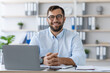 © Prostock-studio - Happy middle aged caucasian man with beard in glasses working with laptop in office or flat interior, free space. Business and work at home, freelance, webinar, remote meeting due covid-19 quarantine