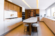 © ADDICTIVE STOCK - Contemporary luxury kitchen with marble island and wood accents