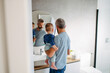 © Halfpoint - Morning routine in bathroom, father combing son hair.