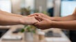 © ArtStockVault - Close Up of Diverse Colleagues Holding Hands for Support in Office