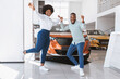 © Prostock-studio - Young black couple cheering and dancing, gesturing YES, celebrating purchase of new car at auto dealership. Full length of Afro family buying automobile, feeling excited at showroom store