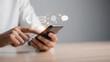 © fei.setiawan - Using a mobile phone to contact and communicate through various digital channels like email and messages for business and personal connections