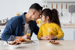 © Prostock-studio - Cheerful Young Arab Dad And Cute Little Daughter Bonding While Eating Breakfast In Kitchen Together, Happy Middle Eastern Father And Funny Female Child Touching Foreheads And Smiling To Each Other