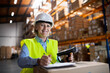© Halfpoint - Senior warehouse woman worker working with barcode scanner.