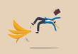 © Premium Shop - Business mistake or accident, insurance, disaster suddenly happened without warning or risk and danger in investment concept, businessman running and slipping with big banana peels on the ground.