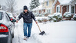 © Vera - Man joyfully clearing snow from car on winter morning, seasonal cheer