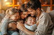 © Creative Pixels - Mom and Dad with their two children hugging in the warmth of their home