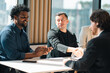 © chokniti - Professional business team having meeting discussing corporate strategy and project results using laptop in modern city environment showing teamwork leadership confident collaboration spirit