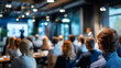 © Laura - Defocused audience engaged in corporate presentation within modern conference setting, blurred professional gathering scene, with copy space