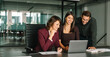 © Stock 4 You - Mature Latin business woman and European young team working using laptop computer in office. Diverse colleagues coworkers group of professional business people discussing project. Banner, copy space