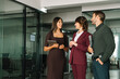 © Stock 4 You - Mature female mentor leader Latin woman collaborating with European young team doing banking talking in office. Teamwork of professional business people working discussing financial trade strategy