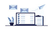 © Triple - Stylish laptop centered on workspace with checklist documents and envelopes in a modern office setup