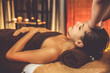 © InfiniteFlow - Caucasian woman enjoying relaxing anti-stress head massage and pampering facial beauty skin recreation leisure in warm candle lighting ambient salon spa in luxury resort or hotel. Quiescent