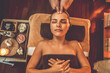 © InfiniteFlow - Caucasian woman enjoying relaxing anti-stress head massage and pampering facial beauty skin recreation leisure in warm candle lighting ambient salon spa in luxury resort or hotel. Quiescent