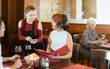 © JackF - Young woman waitress takes order from couple young man and young woman in restaurant