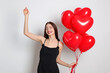 © New Africa - St. Valentine's Day. Beautiful woman with heart shaped balloons on white background