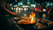 © Jess rodriguez - Street vendor cooking noodles in a wok over a fire at a Bangkok night market; Asian food concept