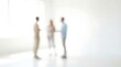 © CuteBee - A blurred image shows three people standing and facing each other in a bright minimalist and modern interior space with white walls